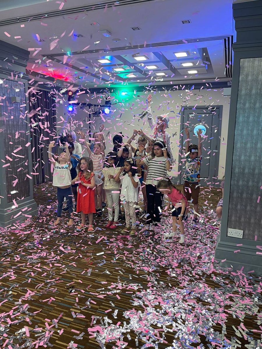 Confetti Show finale with a burst of confetti over a group of children